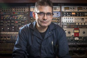 ritratto di Steve Albini in studio di registrazione, con uno sfondo di rack ed effetti